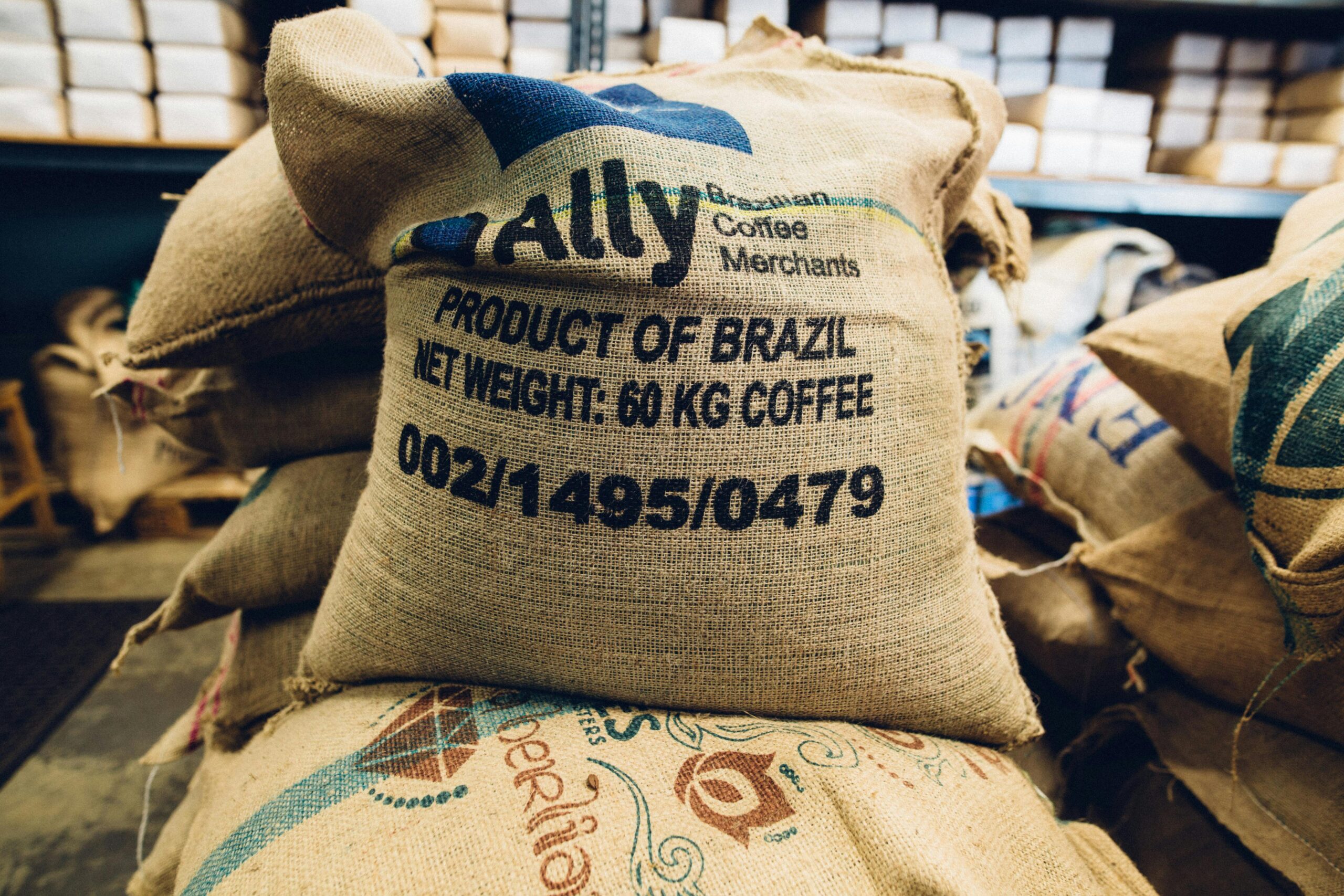 Services Stack of Brazilian coffee bags in a warehouse, highlighting global trade and commerce.